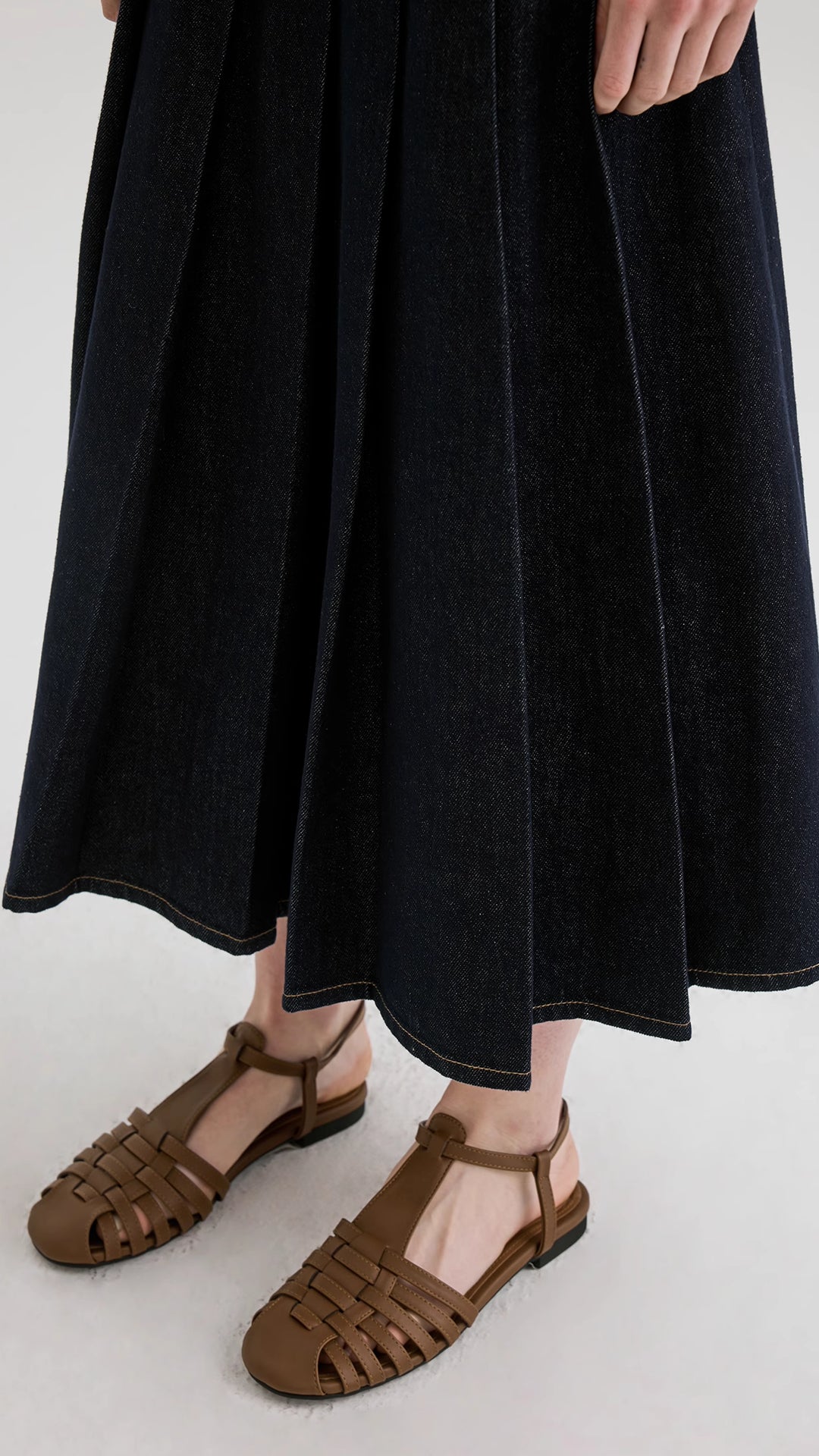 Denim A-line pleated skirt layered with a denim vest set